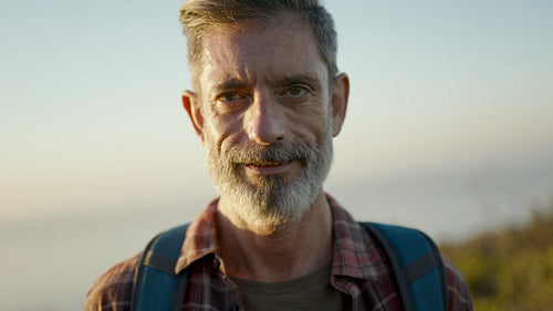 Smiling man hiker on mountain