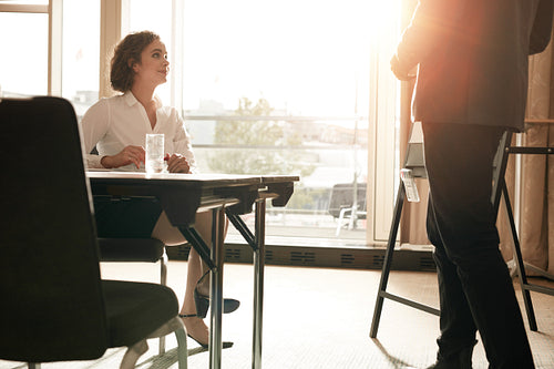 Female executive at conference table during presentation