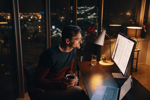 Professional businessman working late at night in home office