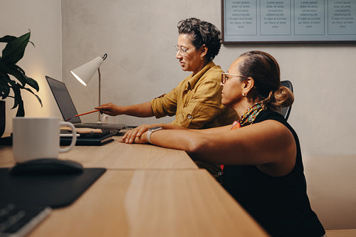 Colleagues discussing project scope and collaboration at a modern workspace