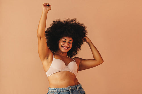 Beautiful woman with Afro hair dancing happily