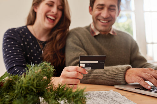 Young couple shopping online for christmas
