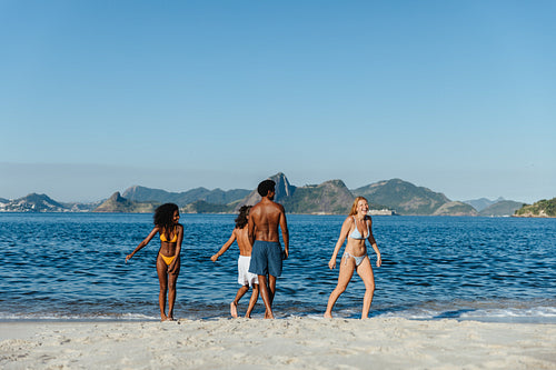 Group of friends enjoying a sunny day at the beach in Brazil