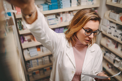 Chemist with prescription searching a medicine