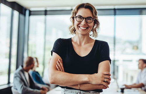Successful businesswoman standing in meeting room