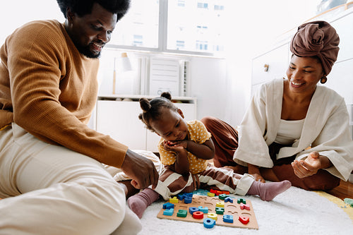 Family plays together with a colorful alphabetical puzzle