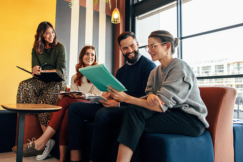 Team of happy businesspeople working in an office lobby