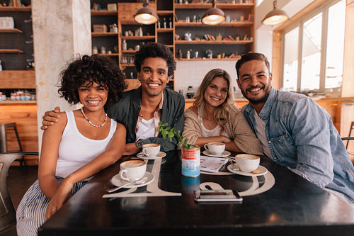 Group of friends sitting together in a cafe