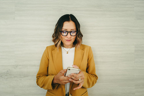 Ethnic businesswoman reading a text message on her smartphone