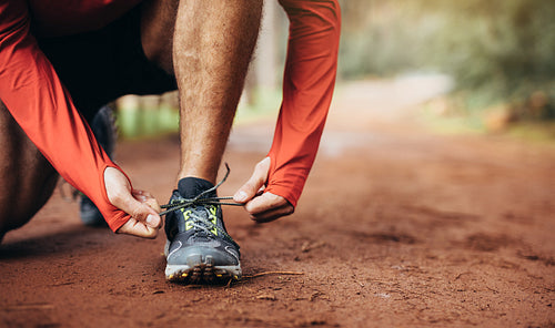 Runner tying shoe laces