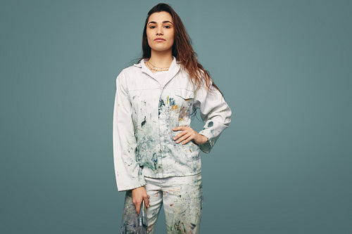 Female painter looking at the camera in a studio