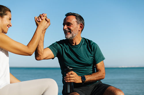 Senior professionals bonding outdoors near the water