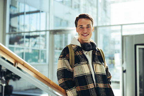 Smiling student at college stairs