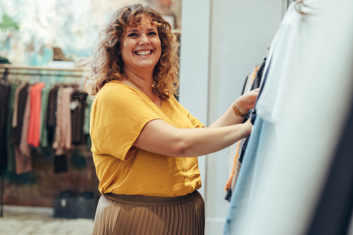 Woman enjoying shopping in clothing store