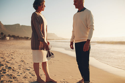 Happy mature couple standing together on the beach 