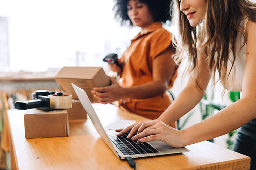 Online store workers scanning parcel boxes in their shop