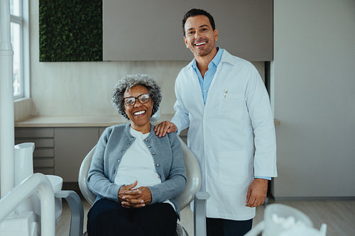 Senior patient in the office, the dentist reviews care after treatment