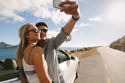 Couple making selfie photo on road trip