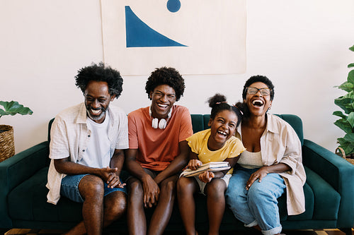 Parents and their kids share joyful laughter at home