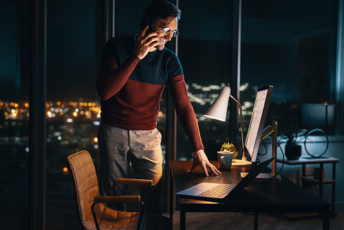 Professional discussing project late at night in office