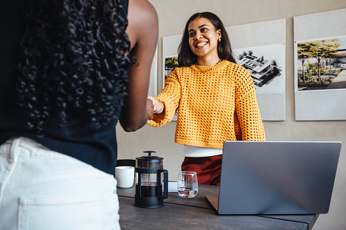 Young female professionals sharing a positive business moment in a modern office