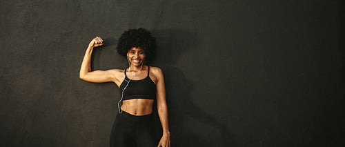 Woman flexing muscles and smiling