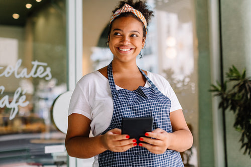 Female entrepreneur in cafe embracing digital technology