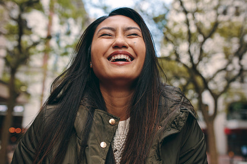 Woman smiling with eyes closed