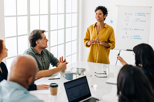 Woman having a discussion with her business team in a boardroom