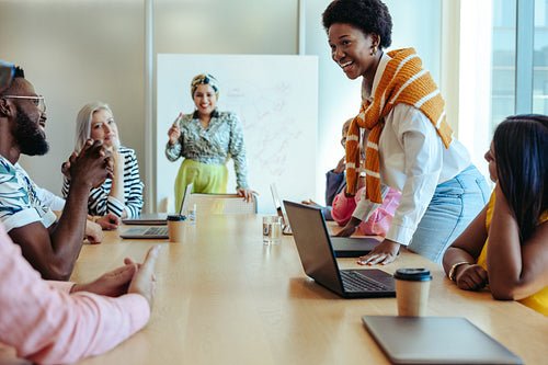 Cheerful colleagues engaging in a collaborative business meeting