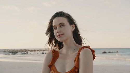 Beautiful woman standing along the beach