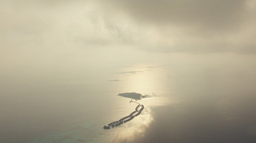 Captivating aerial view of an idyllic island paradise with overwater villas in the tropical ocean