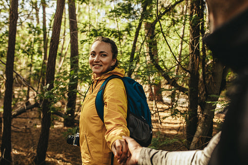 Happy couple on a camping trip walking in forest