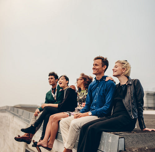 Multiracial friends enjoying on terrace