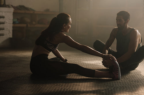 Couple resting after work out at gym