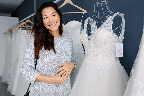 Asian woman shopping for wedding dress