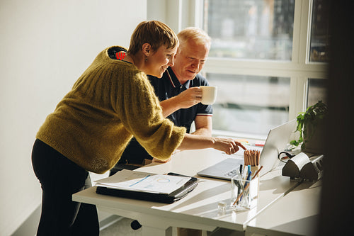 Colleagues working together on a project in the office