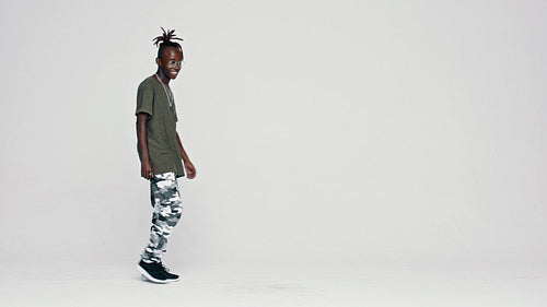 African teenager with dreadlocks dancing