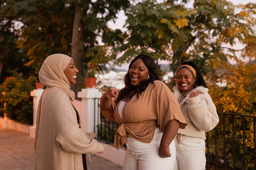 Group of multicultural friends dancing together outdoors