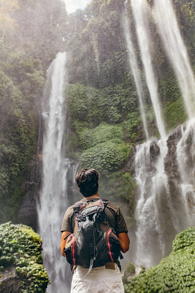 Male hiker looking at waterfall
