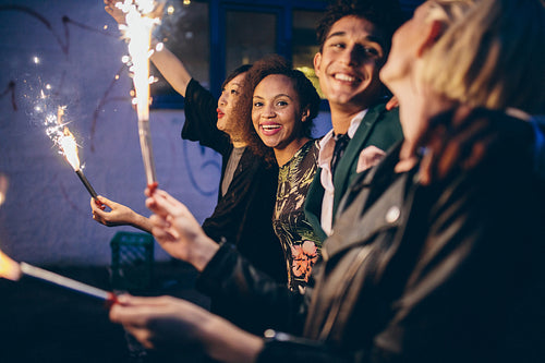 Group of friends partying and enjoying out with sparklers