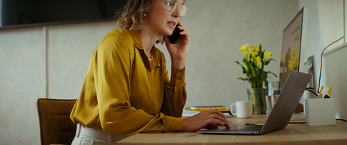 Businesswoman working from her stylish home office