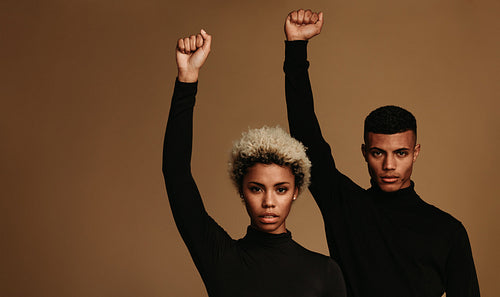 African american couple standing with raised fist