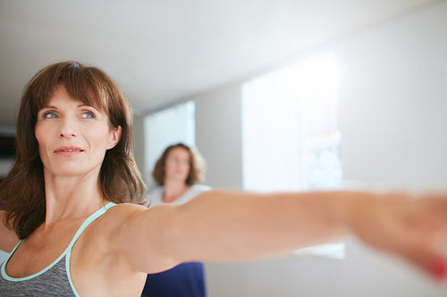 Female trainer doing yoga workout at gym