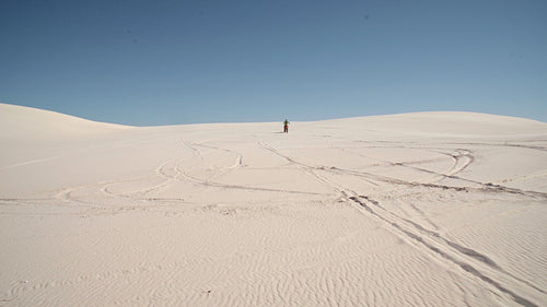 Motocross racer doing a 12 o’clock wheelie in a desert
