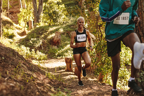 Smiling marathoner running uphill