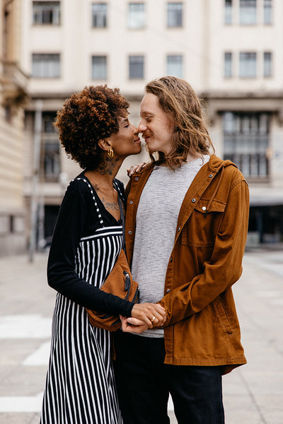 Affectionate embrace on a city street with an urban backdrop
