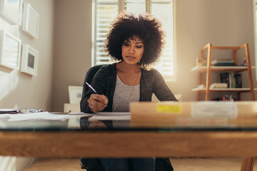 African female architect working at her office