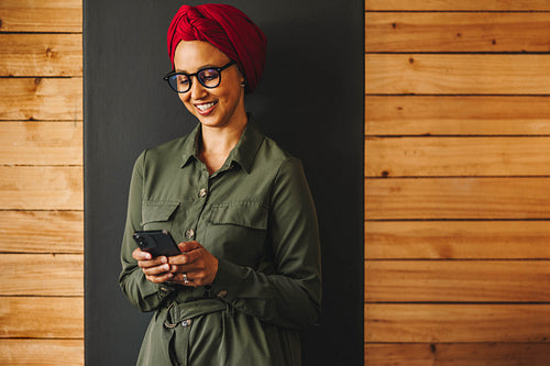 Muslim businesswoman using a smartphone in a modern office
