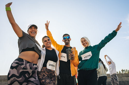 Diverse group celebrating after completing a half marathon